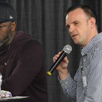 Interviewer speaking into a microphone next to Ben Wallace